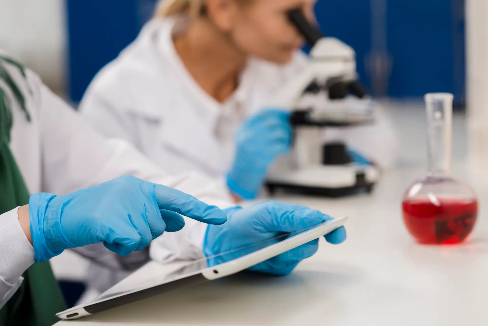 scientists-lab-working-with-microscope-tablet cosm bel